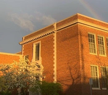 Loyal Heights school building with a rainbow above